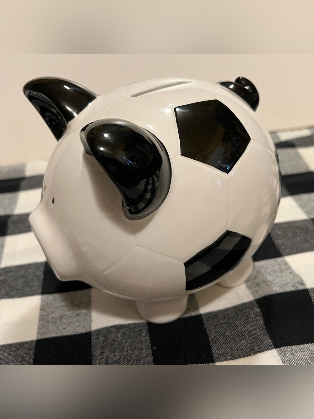 CERAMIC SOCCER THEMED PIGGY BANK.